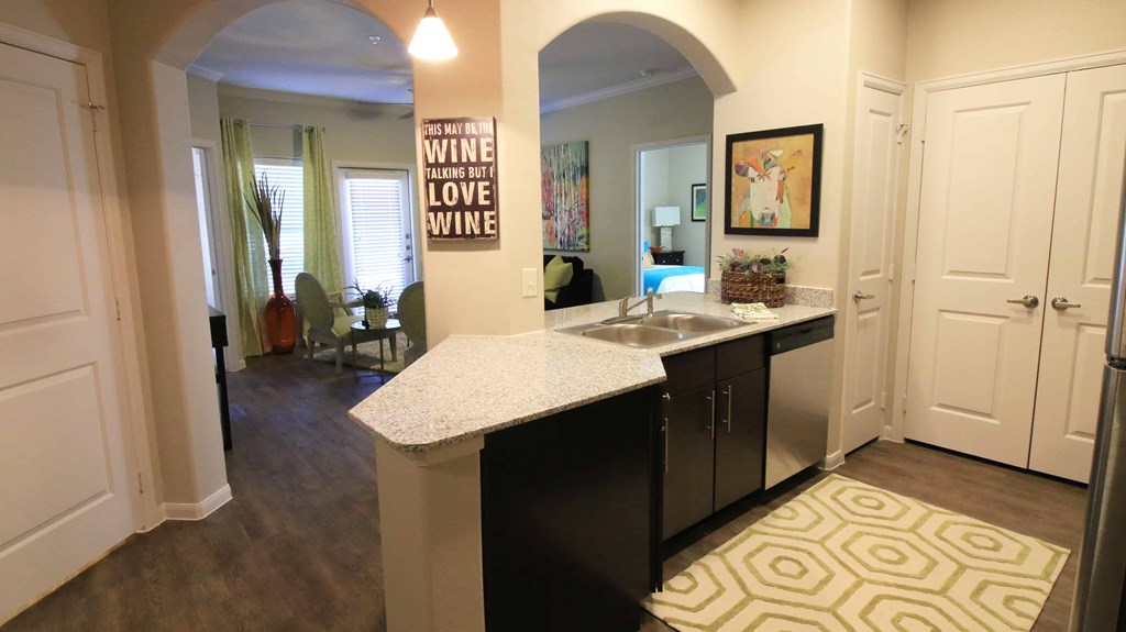 A kitchen with a counter top and a sign that says "Wine is Love".