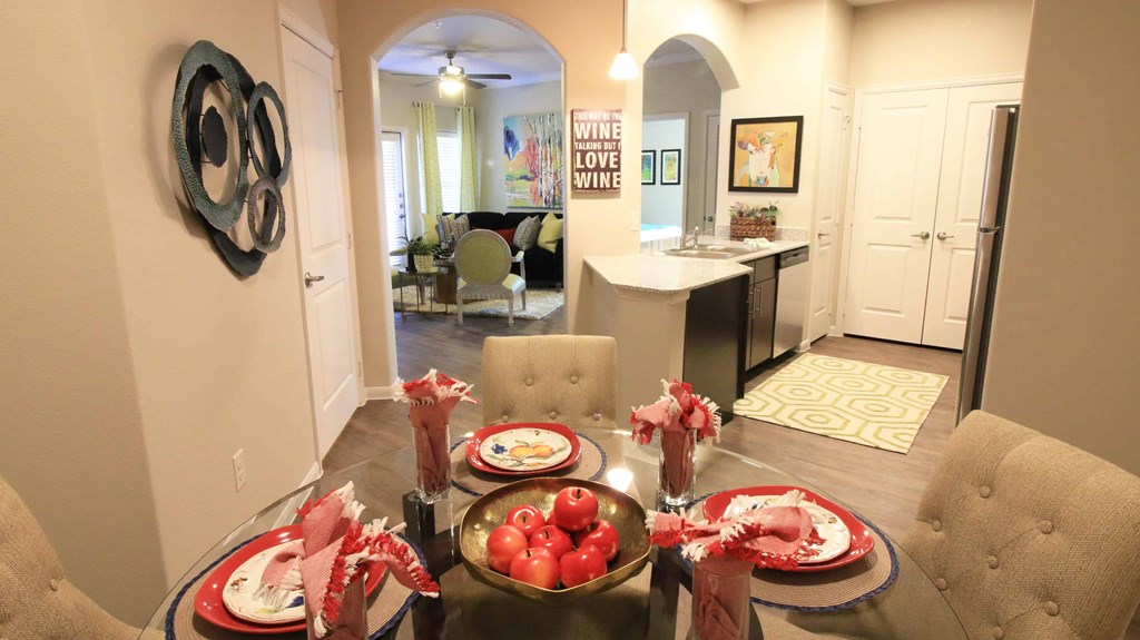 A dining room with a table set for a meal.