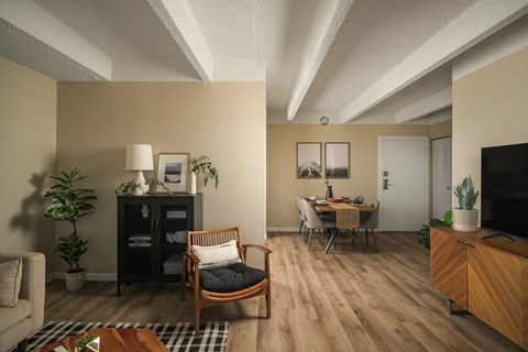 A living room with a wooden floor and furniture.