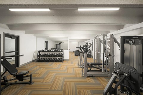 A gym with a variety of equipment including a bench, weights, and a leg press machine.