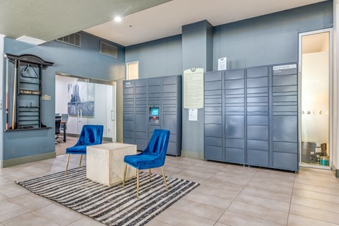 A room with blue chairs and a white table.
