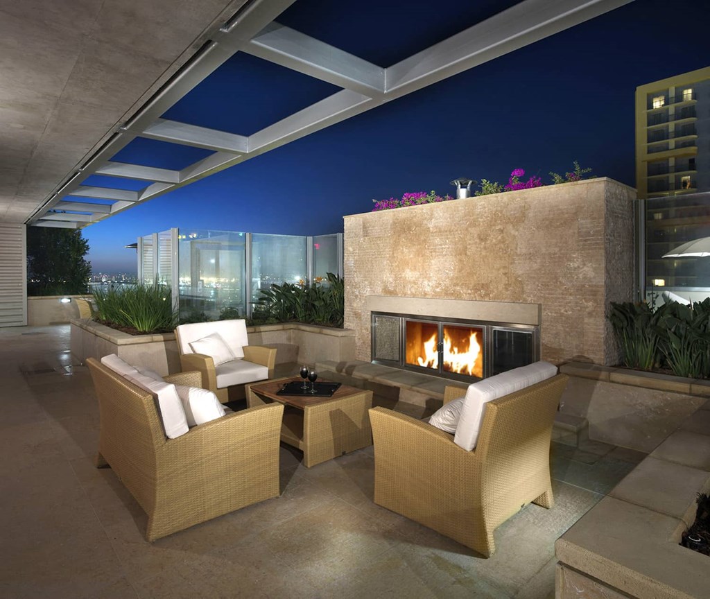 a fireplace on the terrace of a luxury condo at night