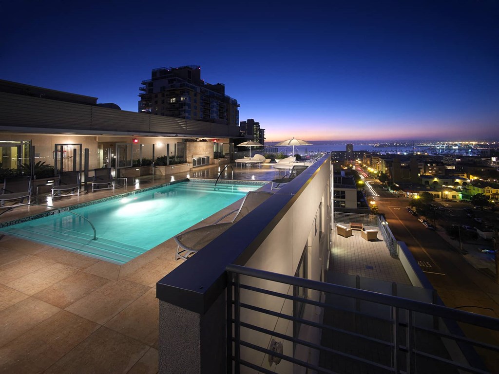 a view of a pool and a city at night