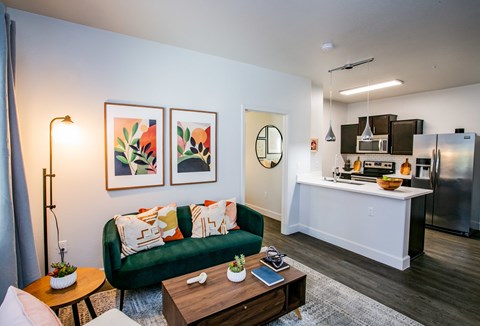 A living room with a green couch and a coffee table.