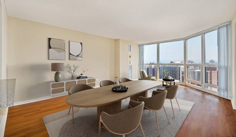 A modern dining room with a large table and chairs.