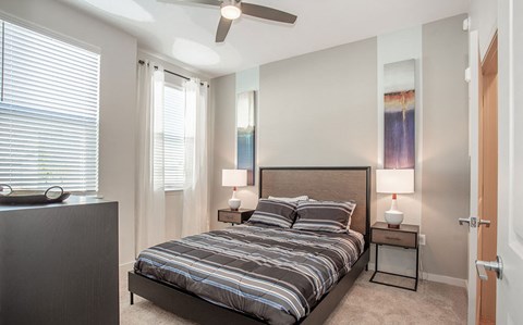 a bedroom with a bed and a ceiling fan