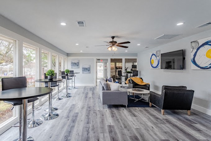 a living room with couches and chairs and a tv