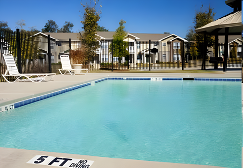 A swimming pool with a 5 ft diving board.