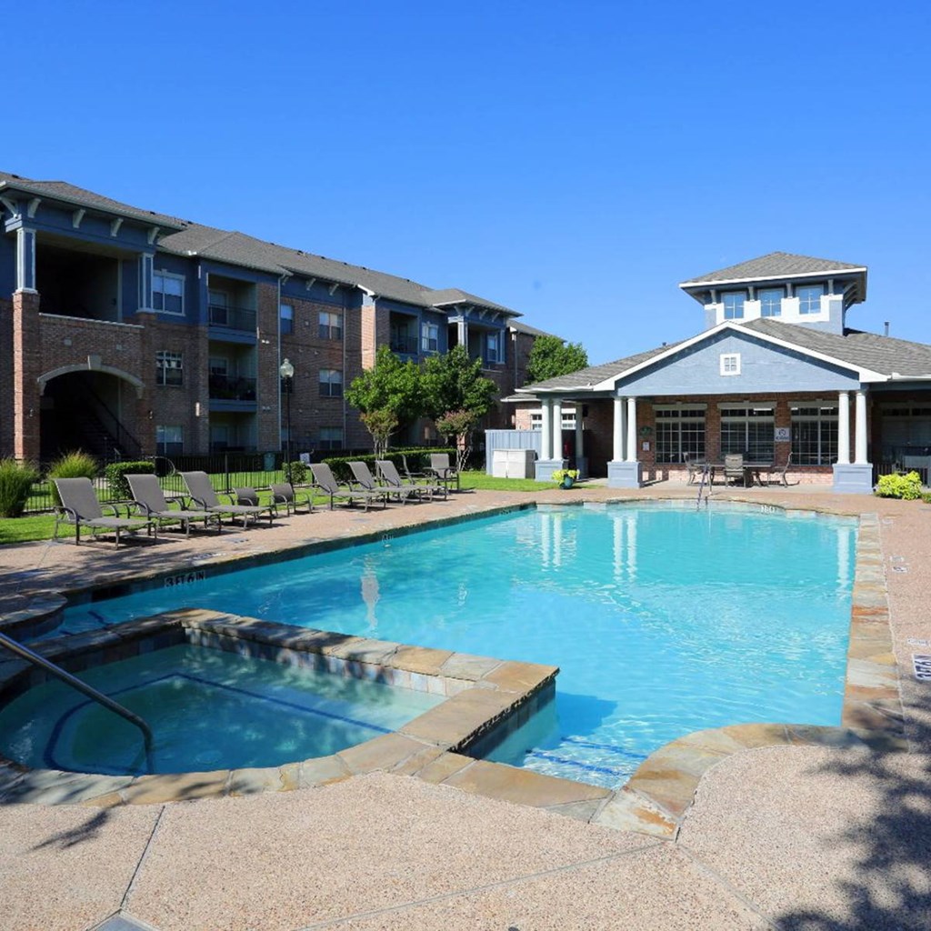 a swimming pool with a building in the background