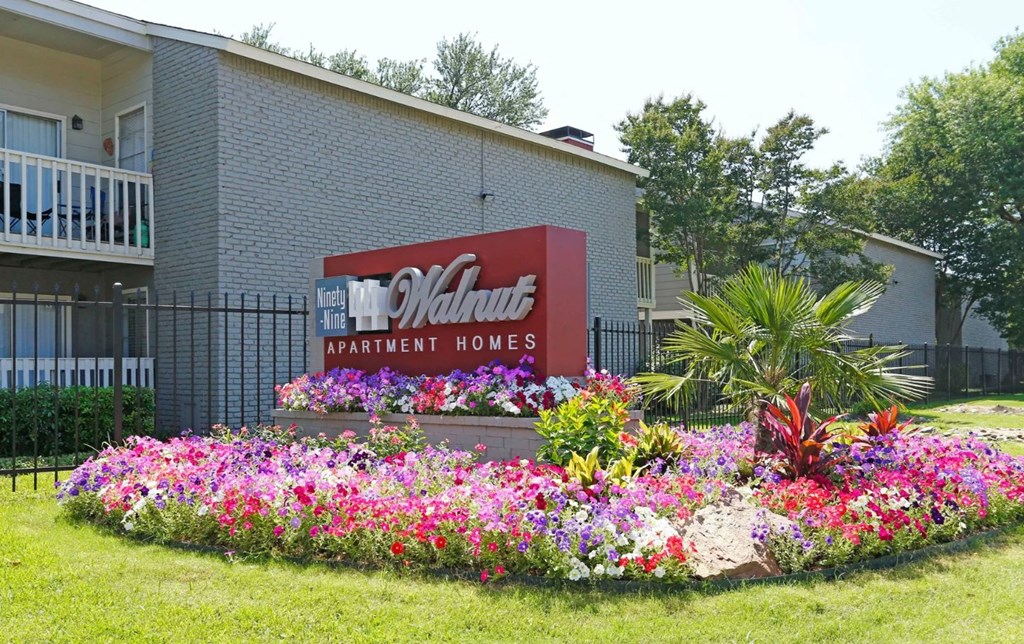 a bed of flowers in front of a building