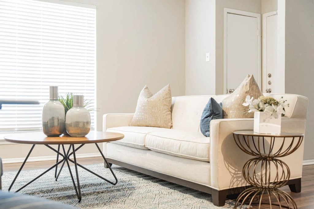 a living room with a couch and tables