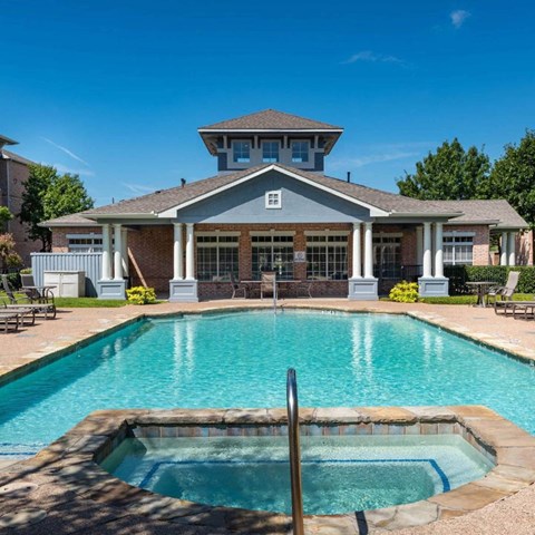a swimming pool with a house in the background