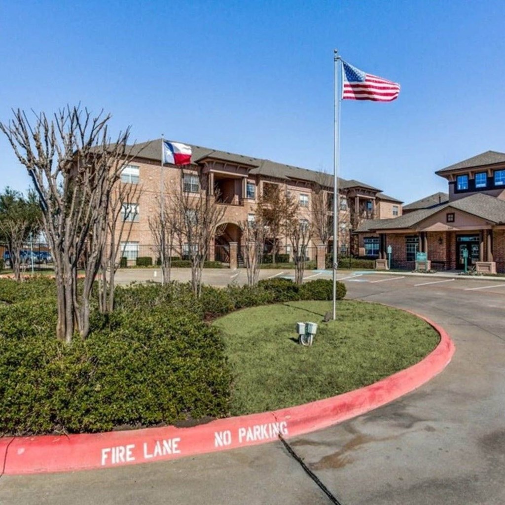 an flag is flying in front of a large building