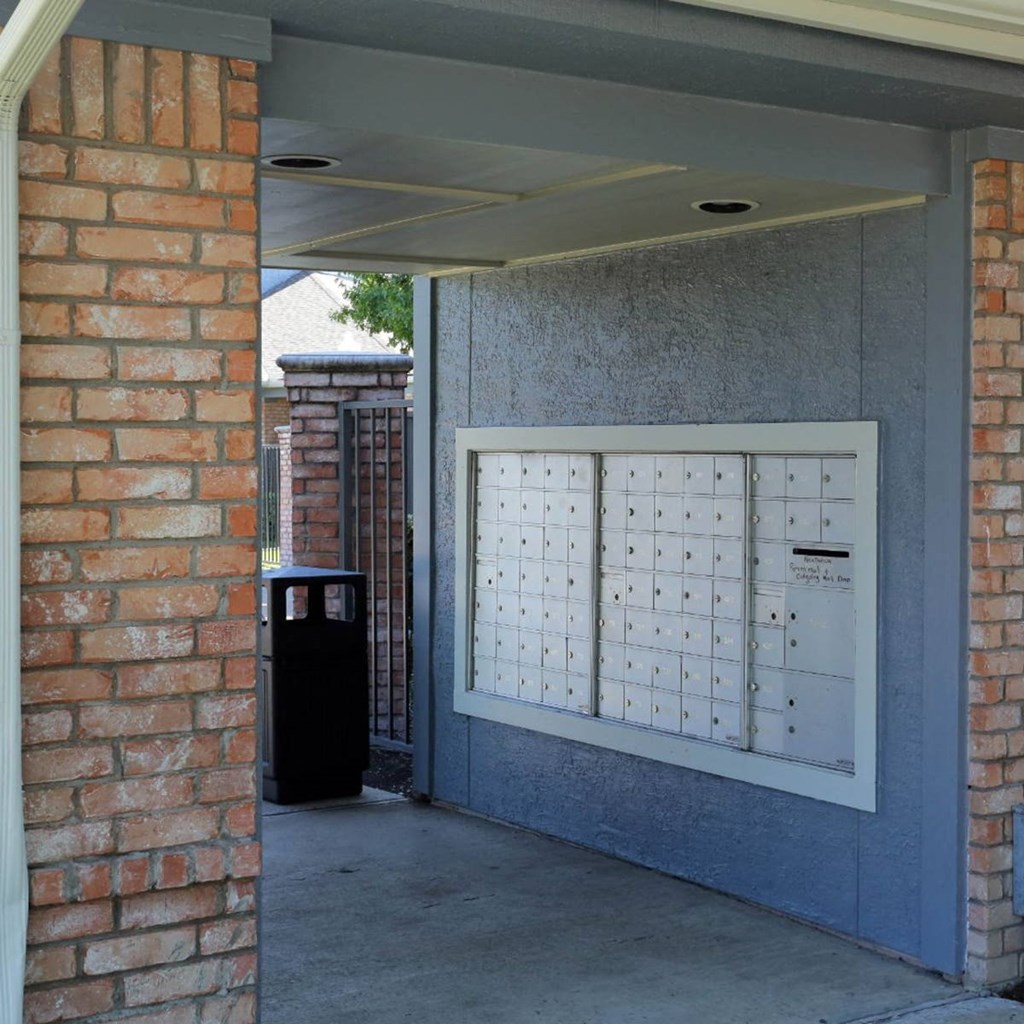 the front door of a building with a mail box on it