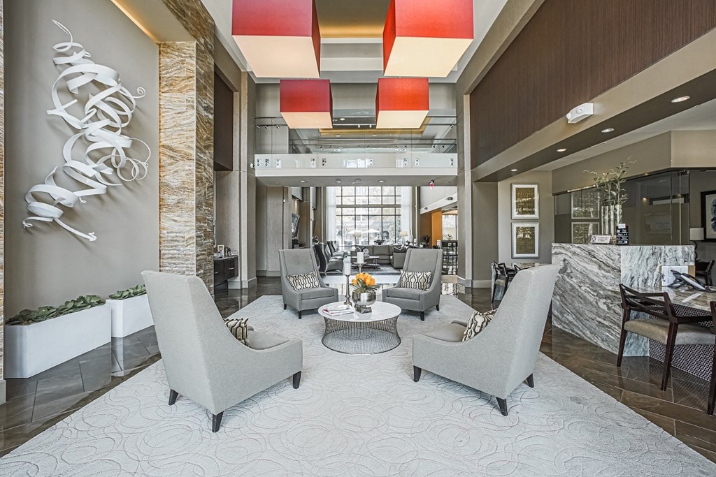 A living room with a large grey sofa and a coffee table.