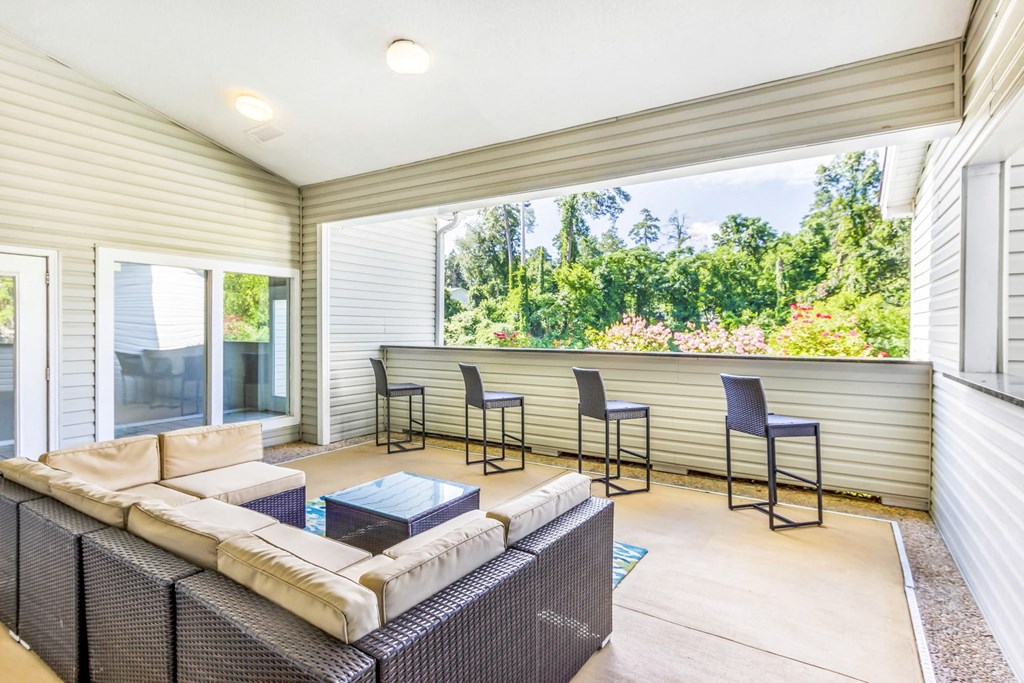 a living room with a couch and chairs and a large window