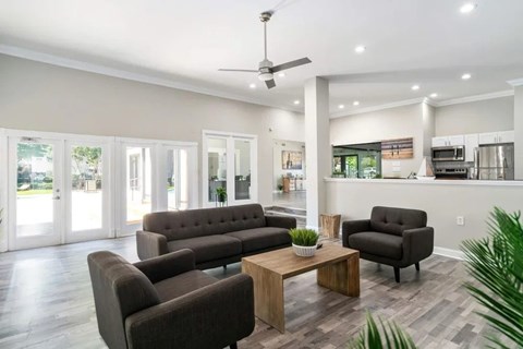 A living room with a grey sofa, armchairs and a coffee table.