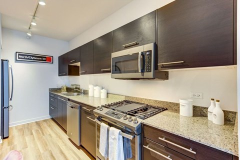 A kitchen with a stove top oven and a microwave.
