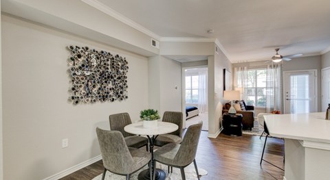 A dining room with a white table and chairs.