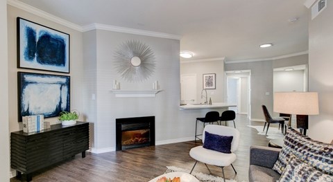 A living room with a fireplace and a painting on the wall.
