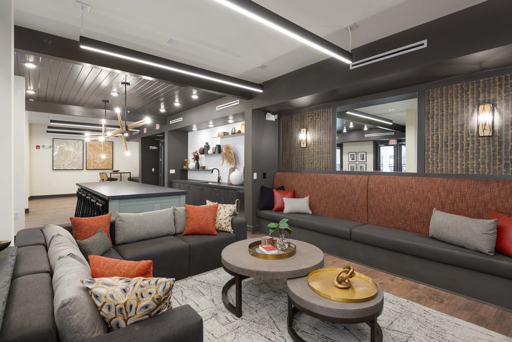 A modern living room with a grey sofa and a wooden coffee table.