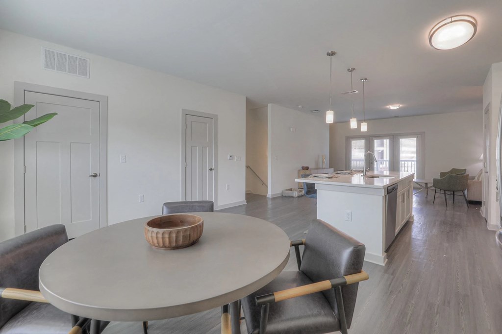 A dining room with a round table and chairs.