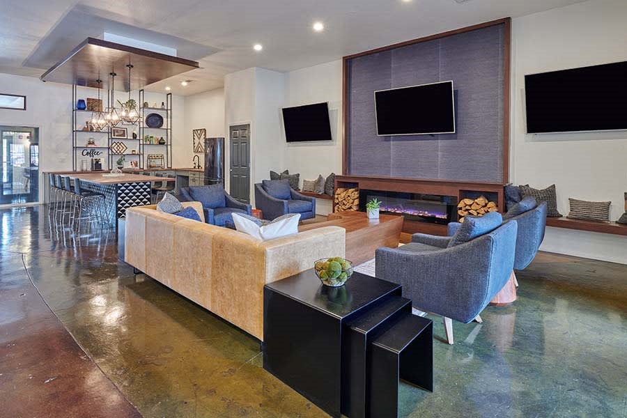 a living room with couches and chairs and a television