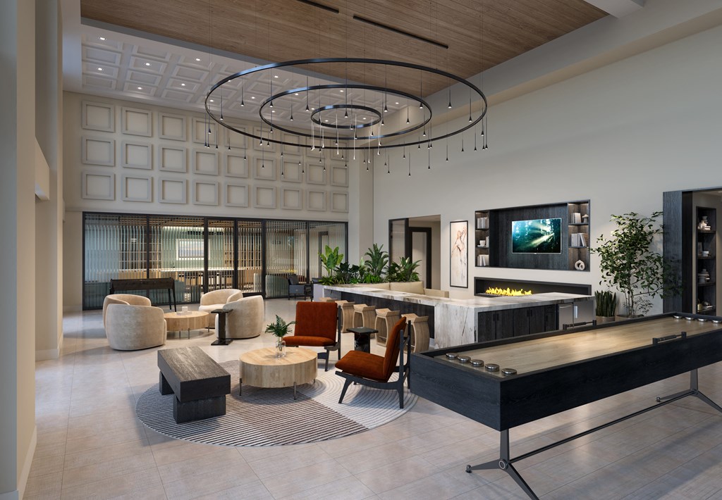 the lobby of a hotel with a lobby area and a reception desk