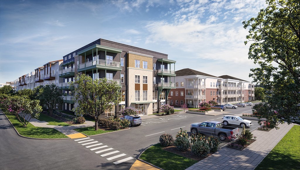 A street view of a residential area with cars parked on the side of the road.
