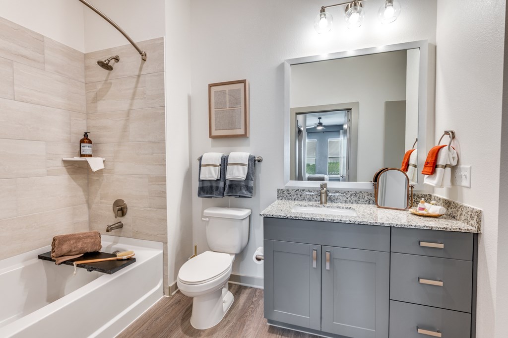 A bathroom with a white toilet, a white sink, and a white bathtub.