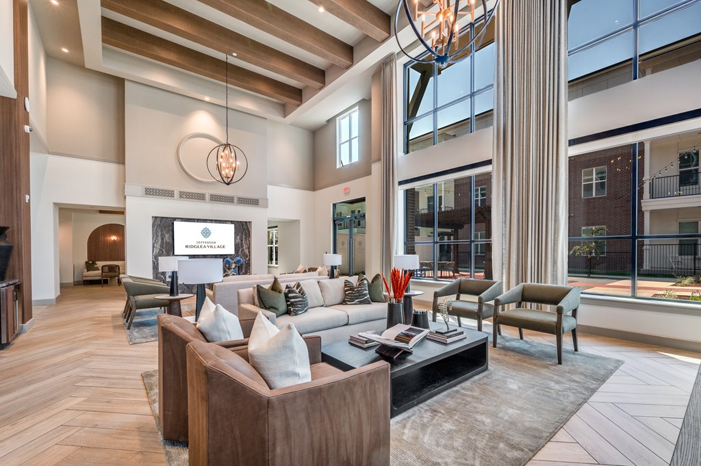 A modern living room with a large window and a fireplace.