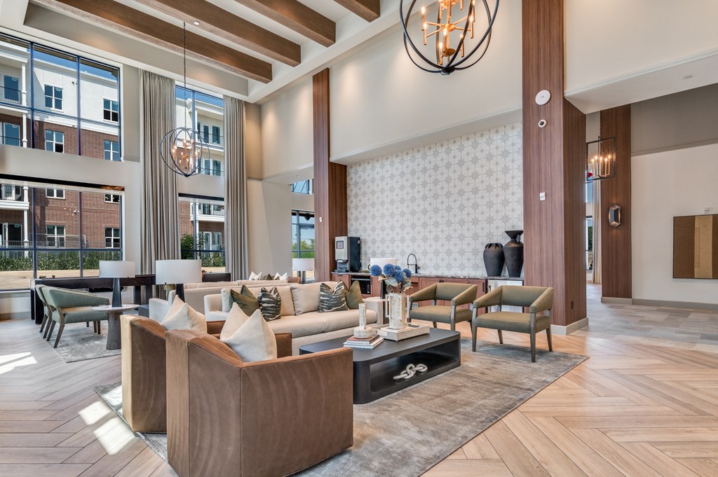 A modern living room with a large sofa set and a chandelier.