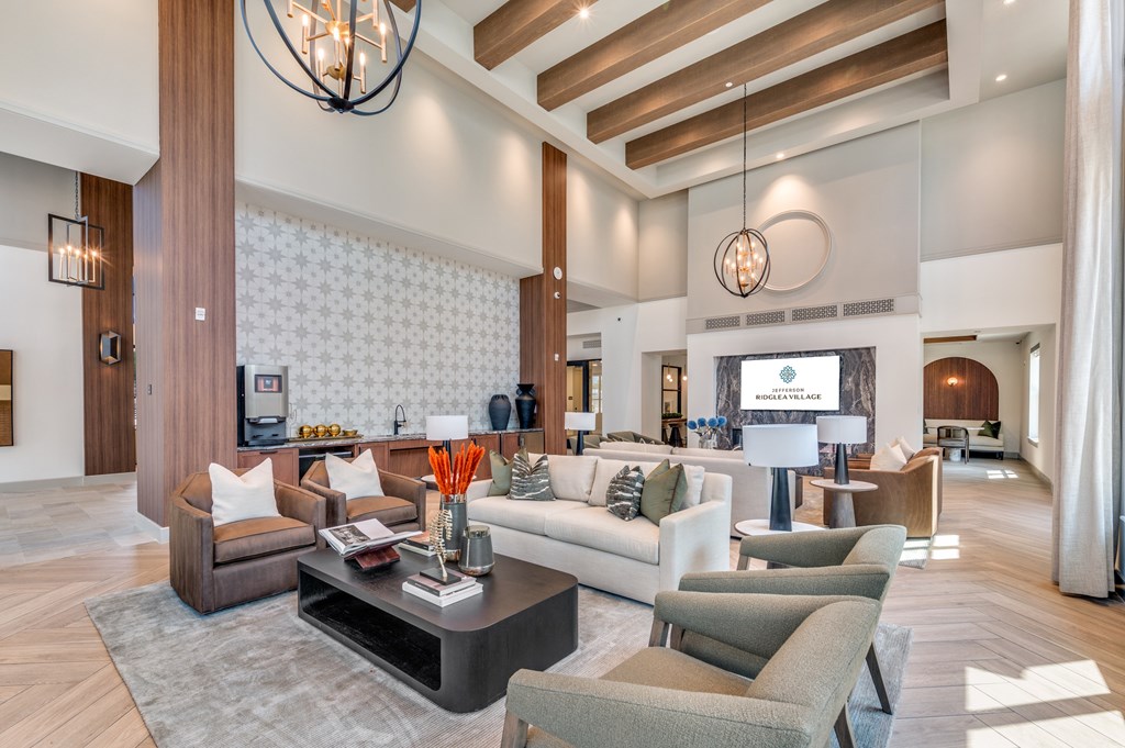 A modern living room with a dark wood floor and furniture.