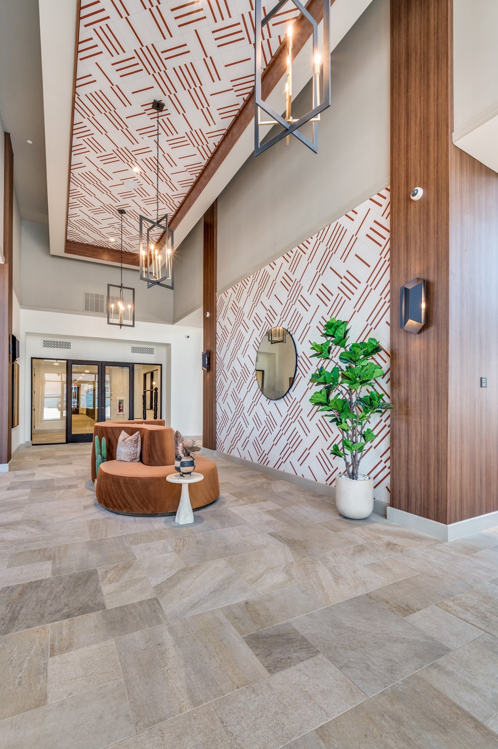 A living room with a patterned wallpaper and a wooden ceiling.