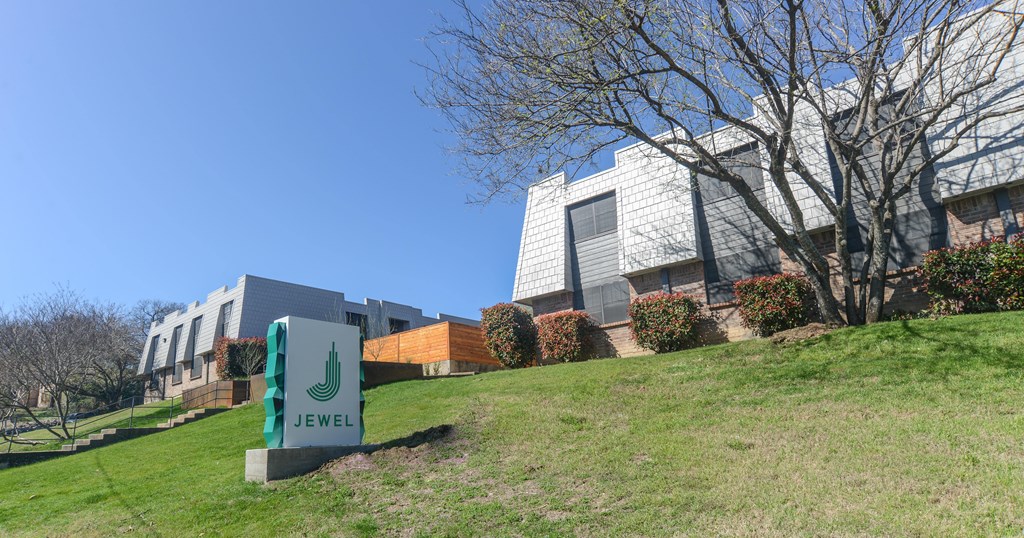 a building with a green sign in front of it