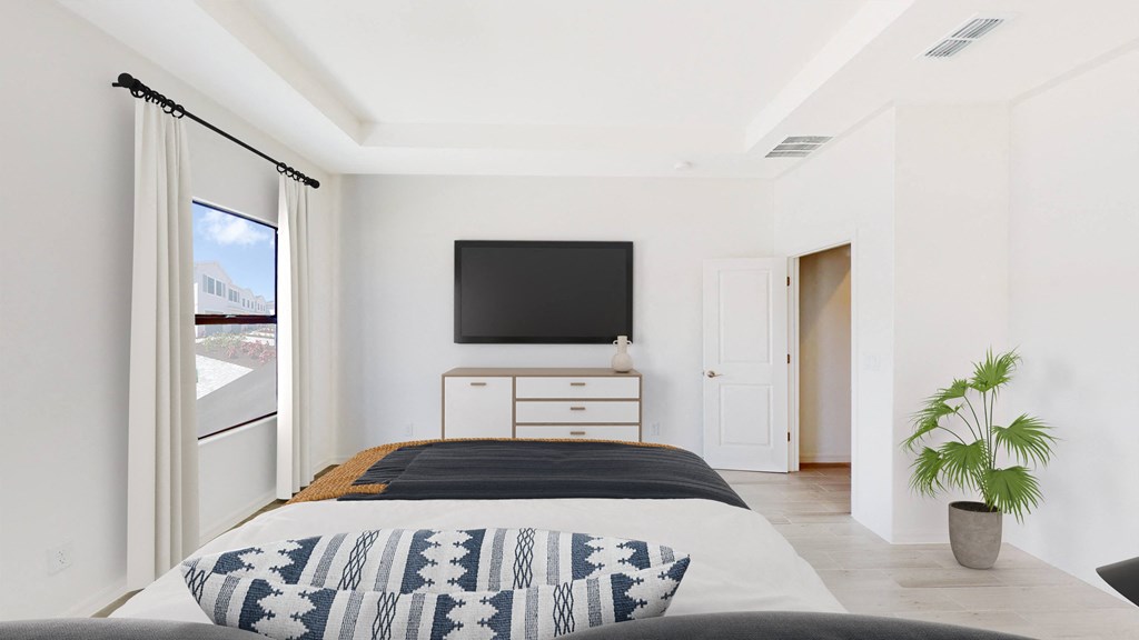 a bedroom with a bed and a tv on the wall