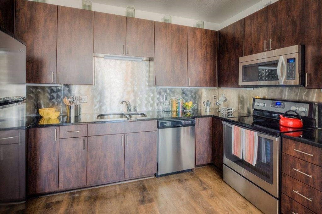 a kitchen with wooden cabinets and stainless steel appliances