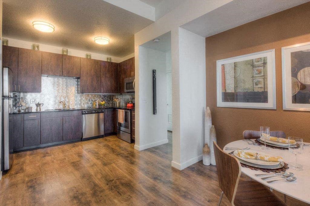 a kitchen and dining room with a table and chairs