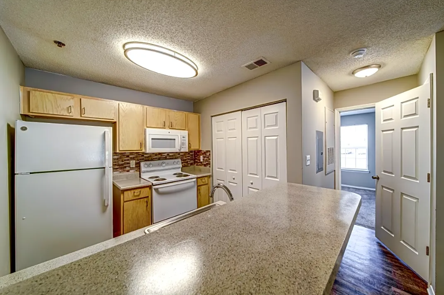 a kitchen with white appliances and a counter top