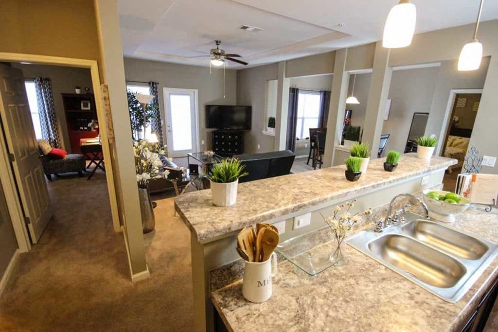 a kitchen with a counter top and a living room
