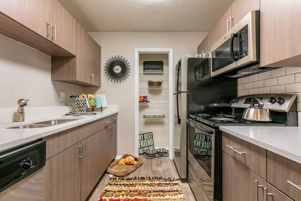 a kitchen with wooden cabinets and stainless steel appliances