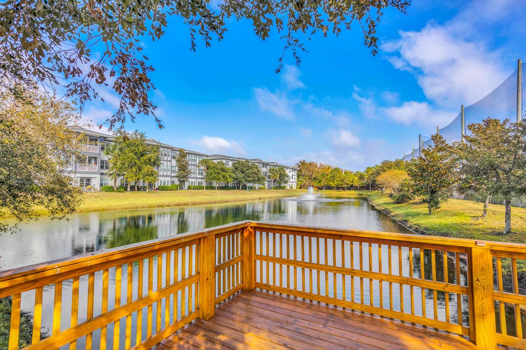 a deck overlooking a body of water with trees