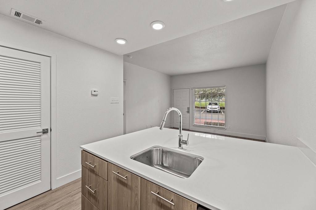the kitchen of our studio apartment atrium with white countertops and a sink