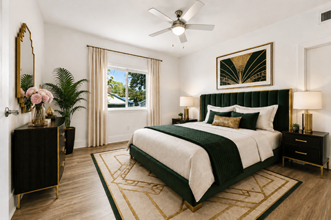 A bedroom with a large bed and a ceiling fan.
