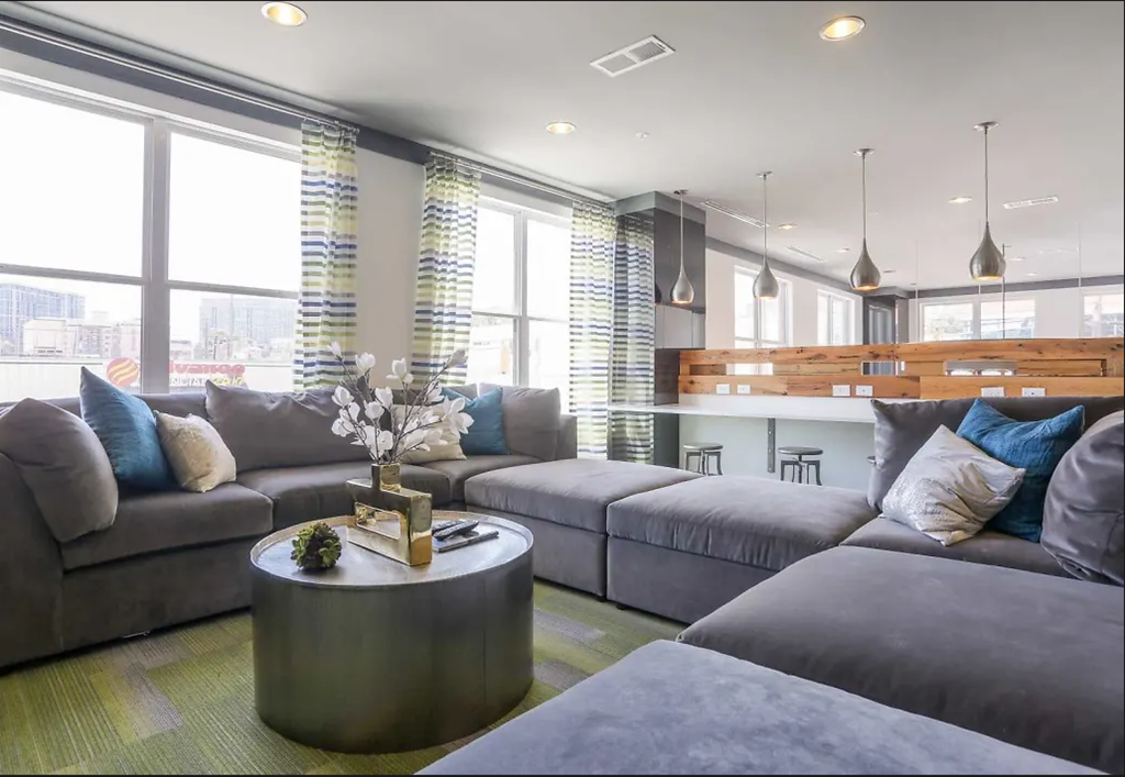 a living room filled with furniture and a large window