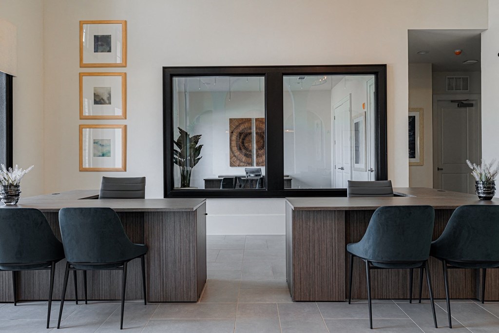 a room with a table and chairs and a large mirror