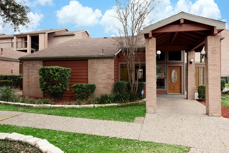 a house with a porch and a sidewalk in front of it
