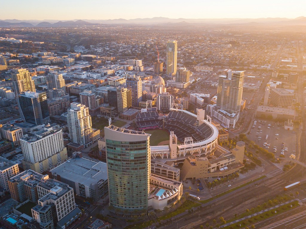 an aerial view of a city with a baseball stadium