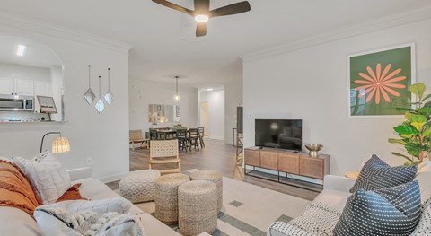 A living room with a white couch and a television.