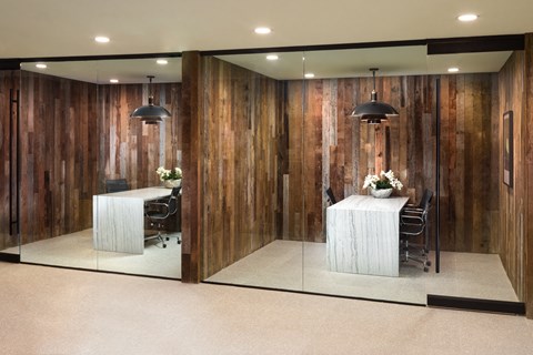 a conference room with wooden walls and a table and chairs